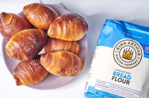 Bag of bread flour next to a plate of salt bread