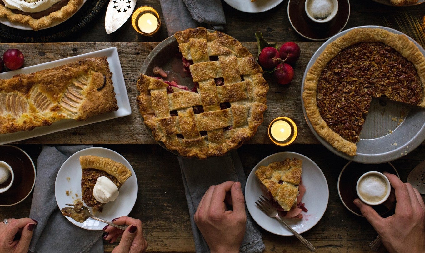 Pies and pear tart on a Thanksgiving table