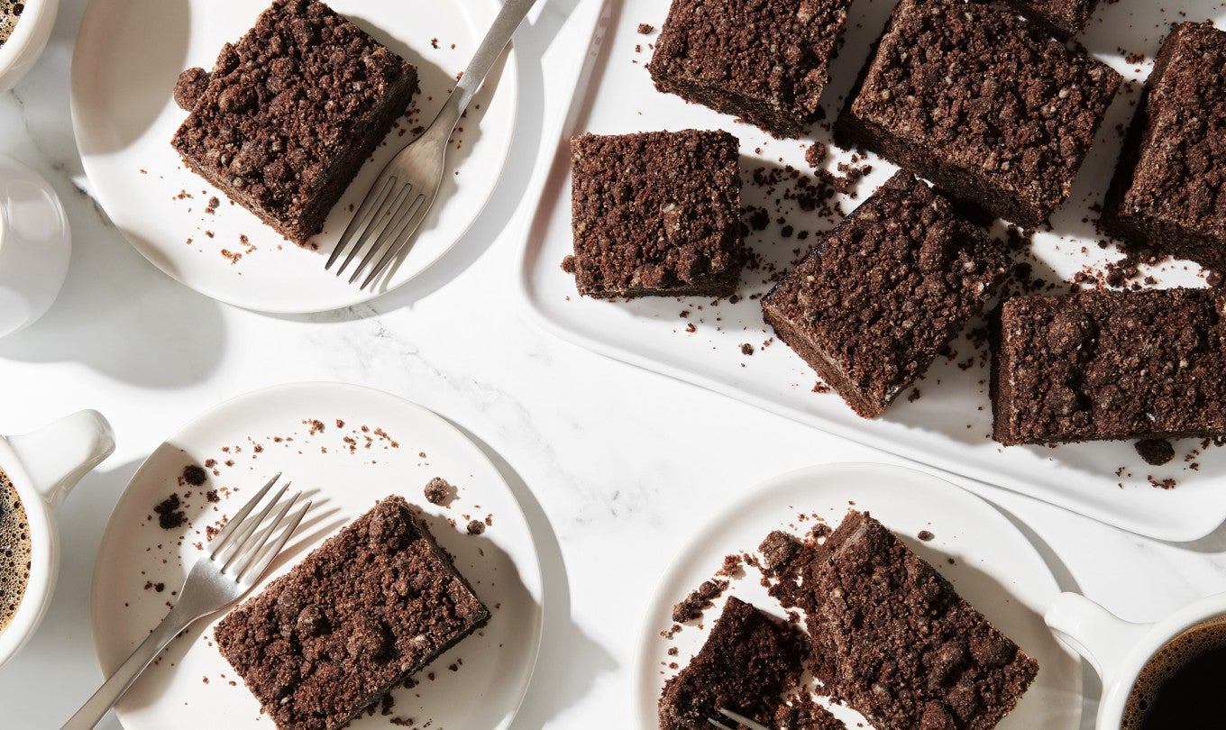 Slices of Rye Chocolate Coffecake on a breakfast platter next to cups of coffee