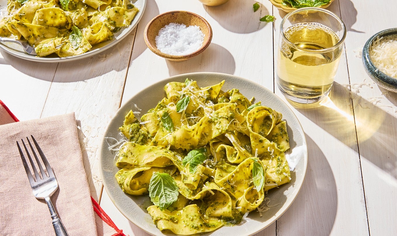 Fresh Pasta on a plate with a glass of wine
