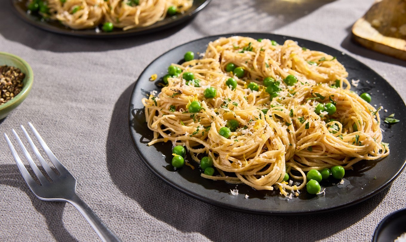 Whole Wheat Pasta on a black plate with a fork