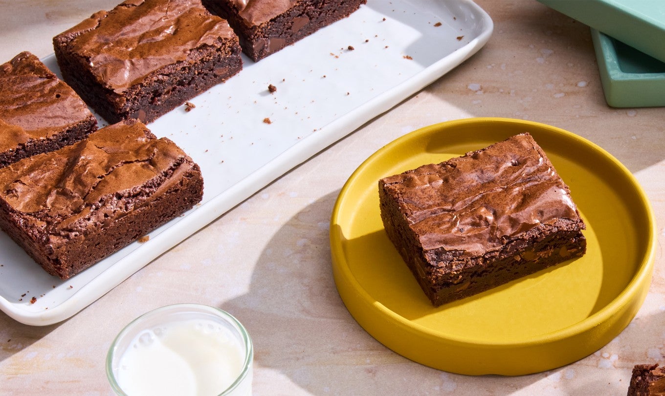 A Small-Batch Brownie on a plate with milk
