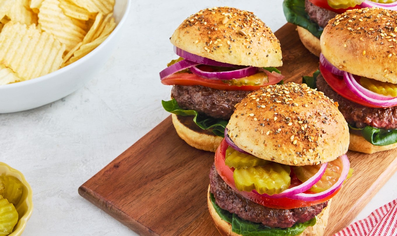 Four Hamburgers on a cutting board