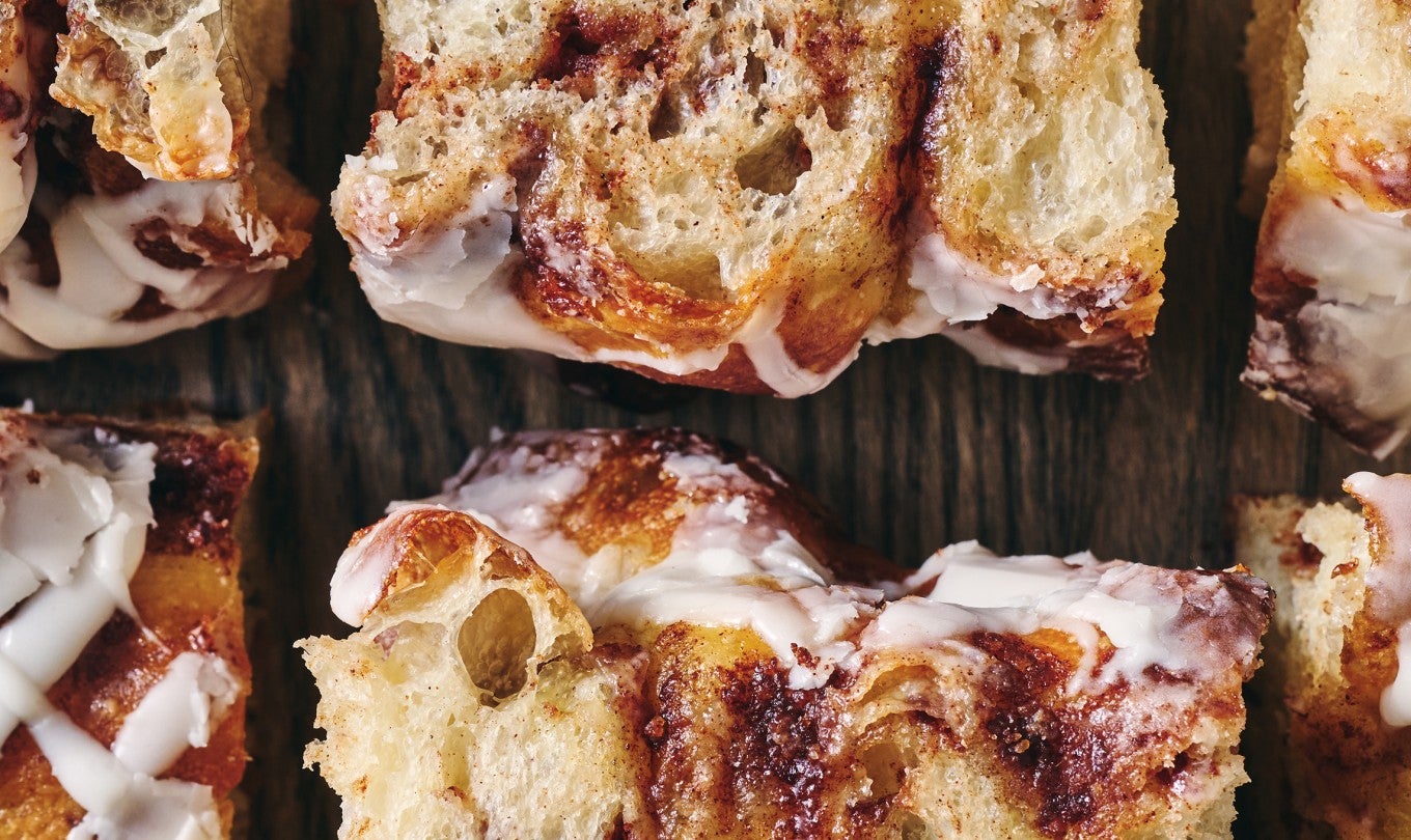 Big and Bubbly Cinnamon Roll Focaccia sliced and laid out on a table