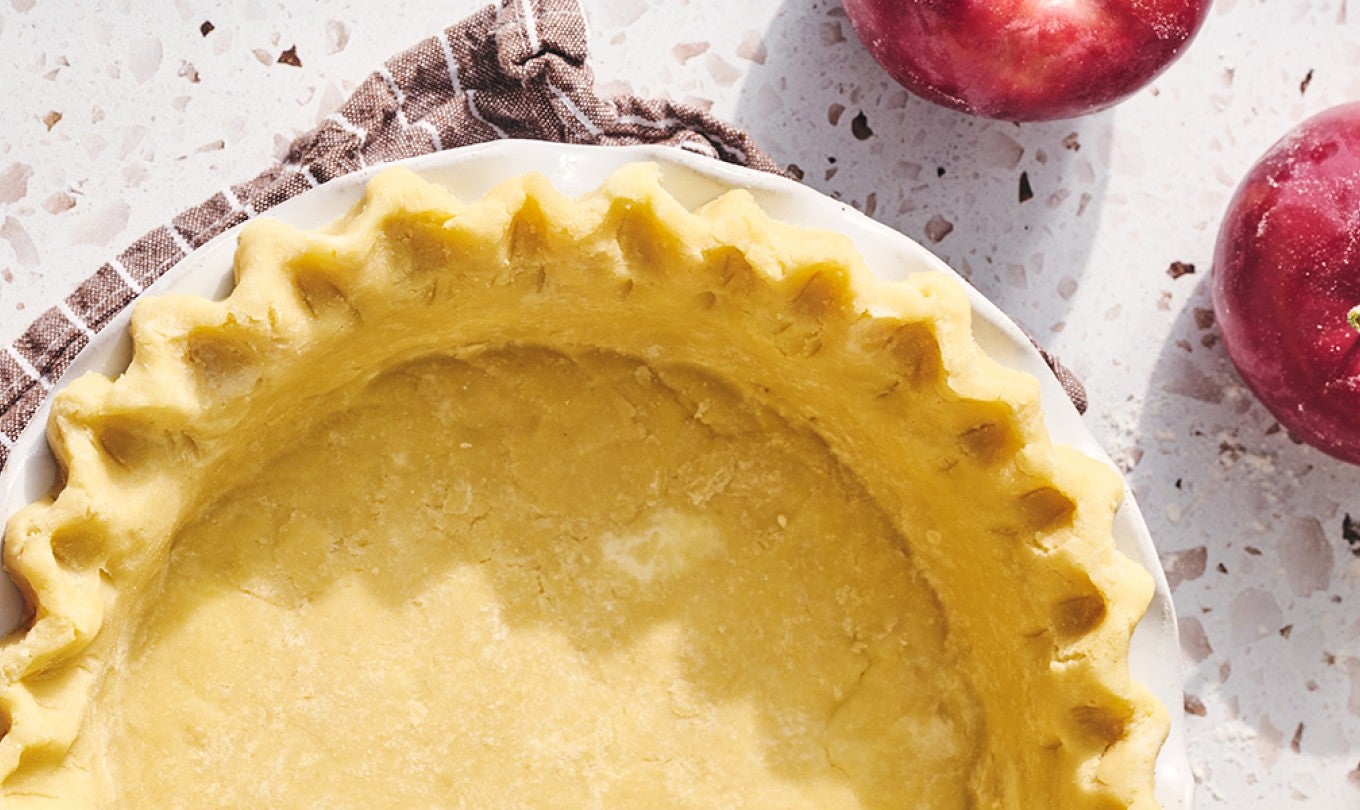 An unbaked Gluten-free pie crust with apples