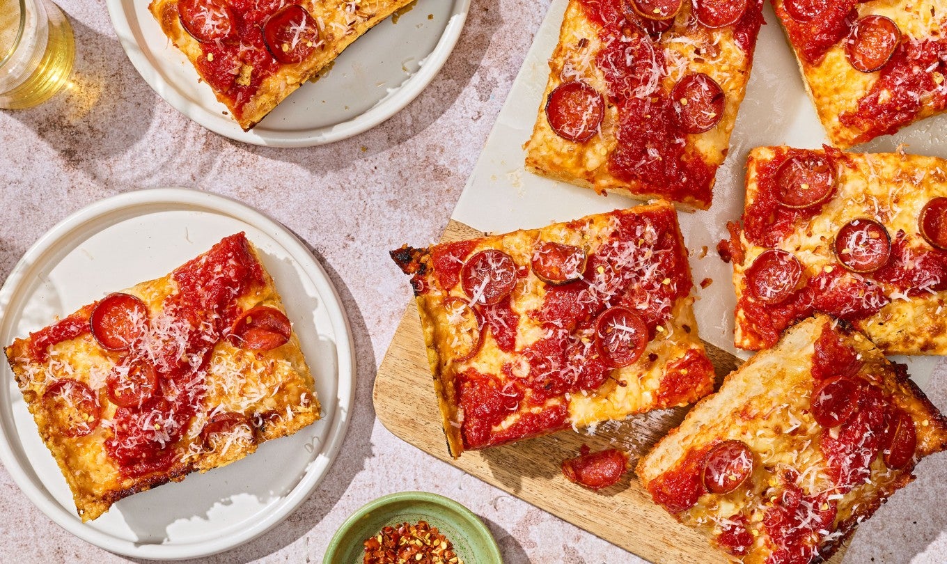 Slices of Weeknight Detroit Pizza arranged on a tabletop shown from above.