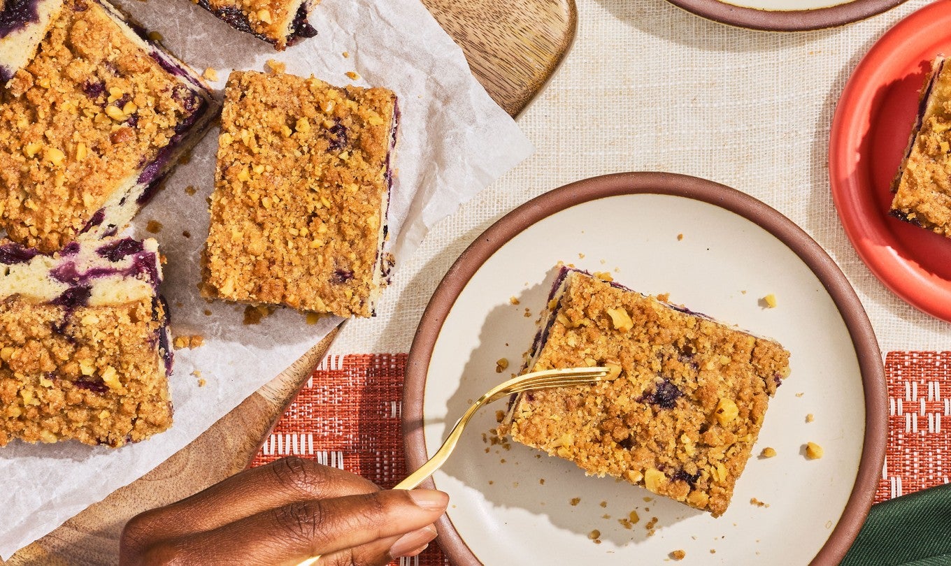 Emancipation Breakfast Cake being sliced while sitting on a plate. Seen from above.
