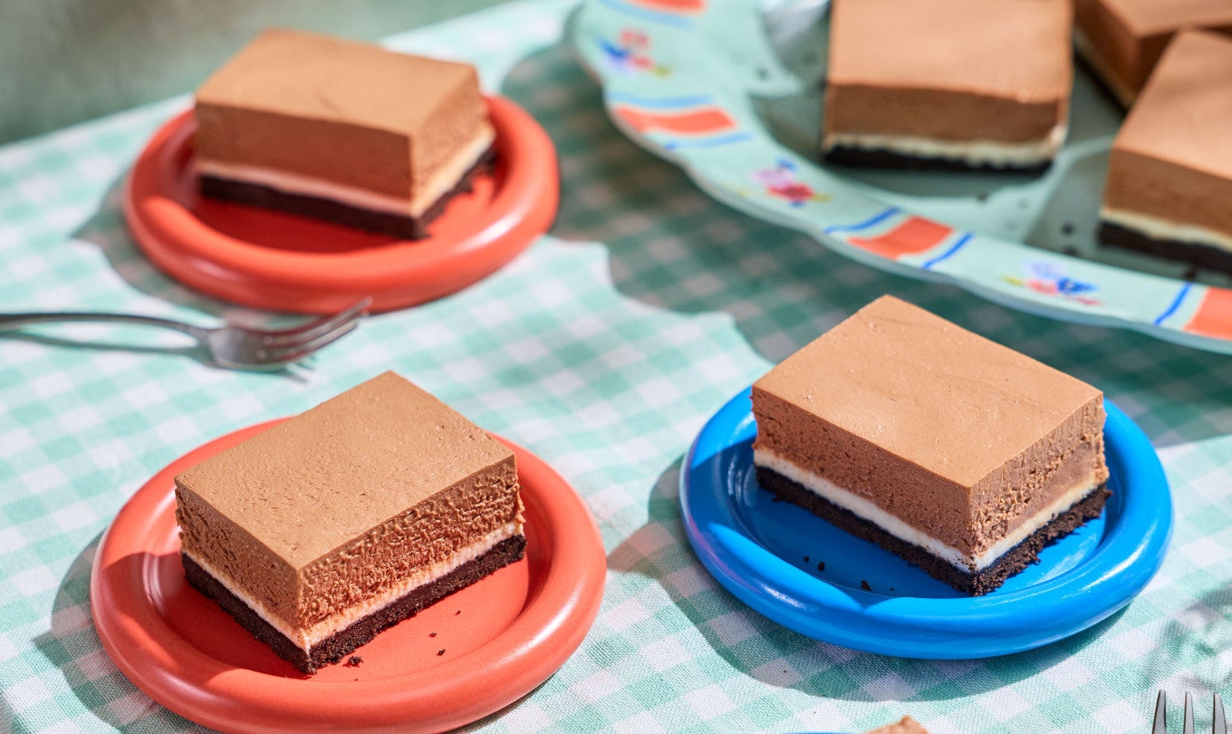 No-Bake Chocolate Cheesecake Bars arranged on a table