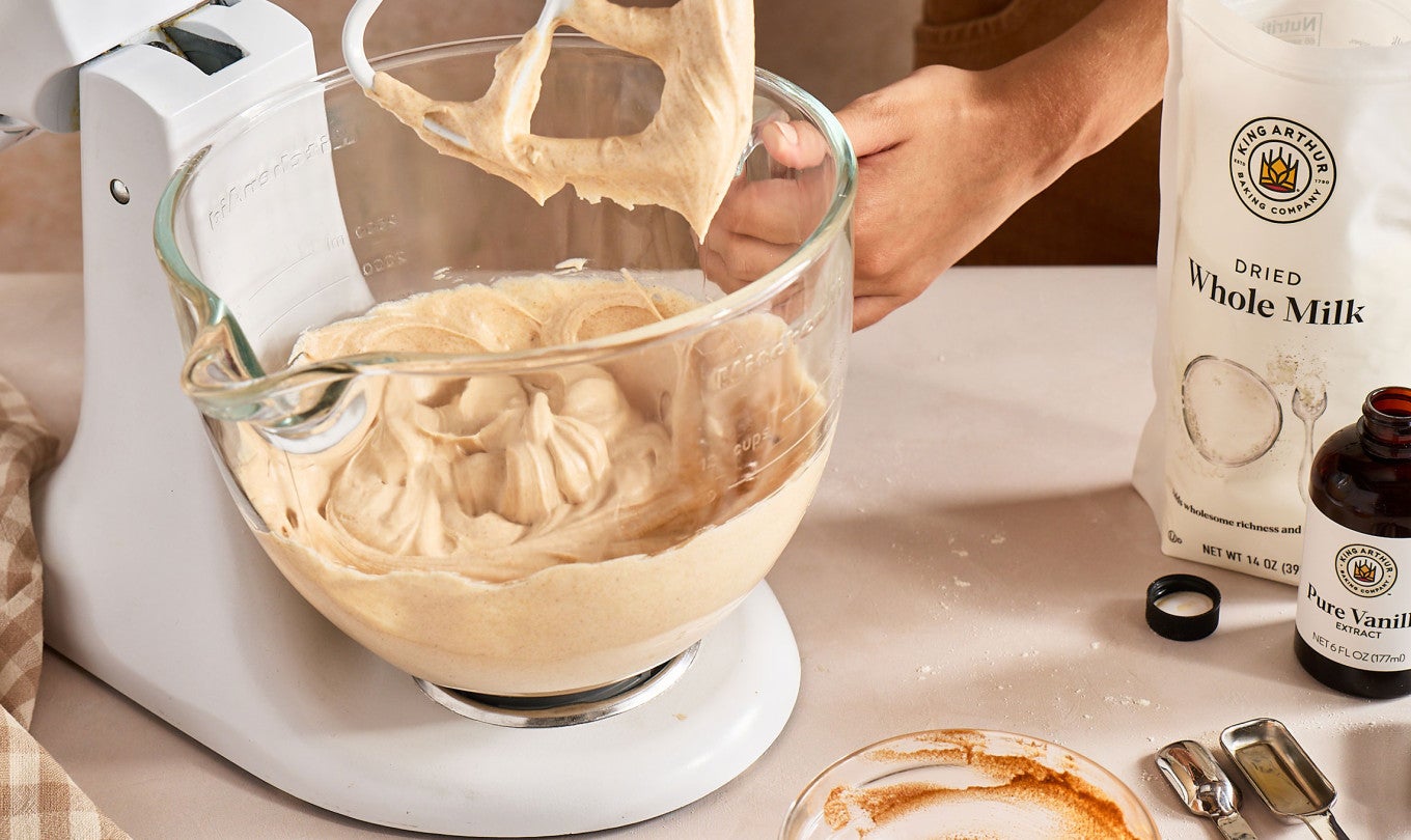 A stand mixer with Brown Butter Cream Cheese Frosting