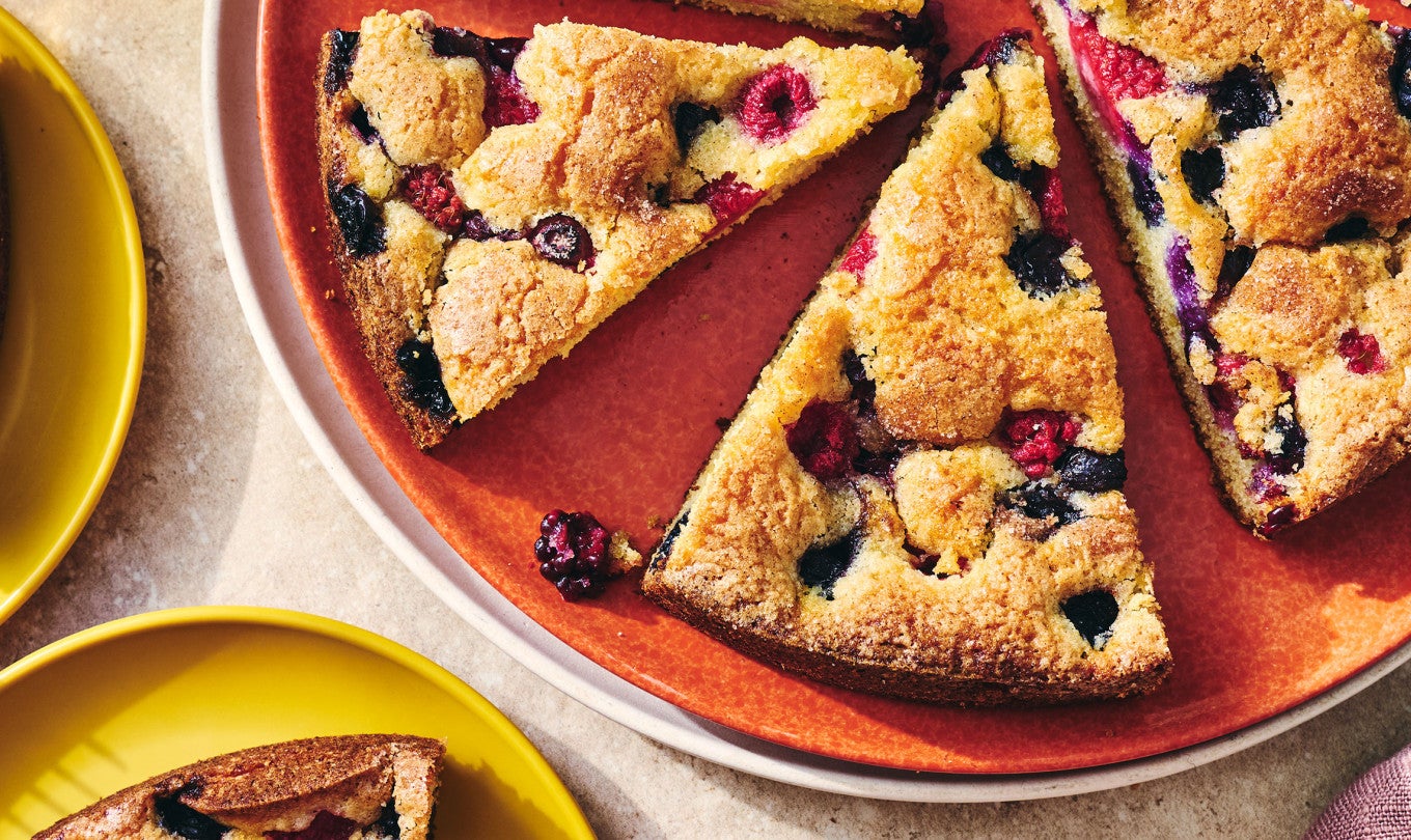 Sliced late summer berry torte on a plate seen from above