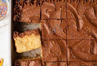 Classic Birthday Cake baked in a sheet pan, sliced and decorated with rainbow sprinkles