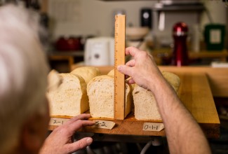 Frank measures loaves of bread in the King Arthur test kitchen