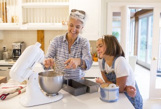 Woman and young girl baking together