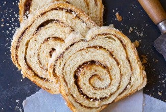 A loaf of cinnamon swirl bread cut into slices