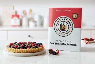 New Baker's Companion cookbook next to tart