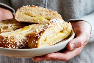 Hands holding plate of lemon bread