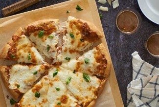 Cheese pizza on cutting board