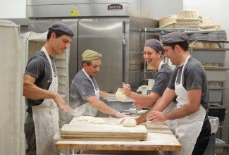 Bakers working together in the kitchen