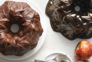 Bundt cake next to dark Bundt pan