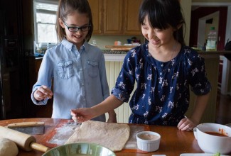 Two young girls baking