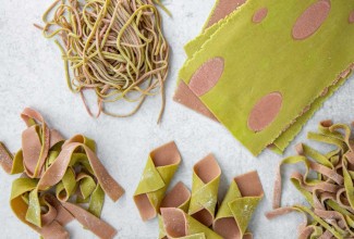 Different shapes of two-toned green and pink pasta