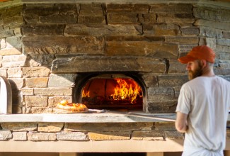 Baker using a wood-fired oven