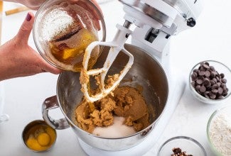 Pouring brown butter into cookie dough