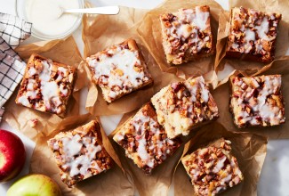 Slices of apple fritter cake on a sheet of parchment 