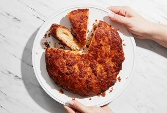 A kouign amann on a plate with a few slices removed