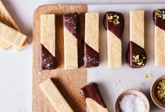 Bars of shortbread dipped in tempered chocolate and sprinkled with salt and pistachios