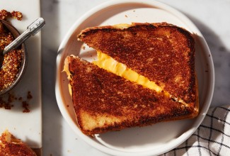Triangles of grilled cheese with cheese pull between them