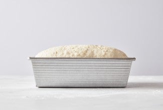 Oatmeal sandwich bread proofing in loaf pan 