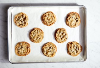 Chocolate chip cookies on a parchment-lined baking sheet.