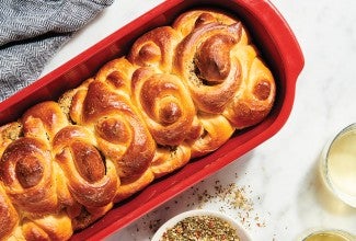 Handkerchief Butterflake Herb Rolls in red ceramic baker on counter