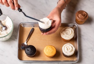 Mini offset spatula being used to frost a cupcake