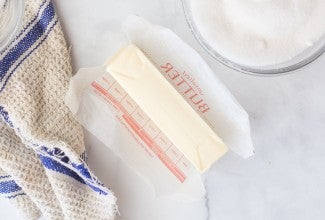 Stick of unwrapped butter on counter