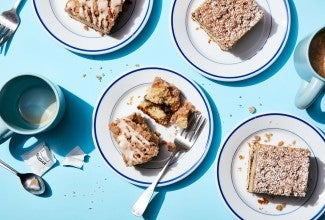 Slices of gluten-free cinnamon-crisp coffee cake on plates with forks