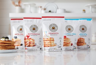 Five different pancake mixes lined up on the counter