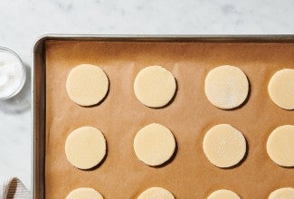 Sugar cookies on parchment-lined baking sheet