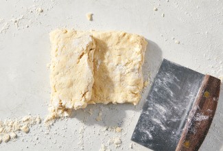 Biscuit dough being folded like a letter