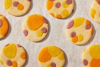 Printed sugar cookies on a piece of white parchment paper. 