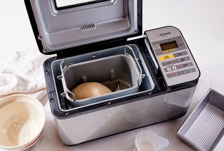 Open bread machine with dough inside