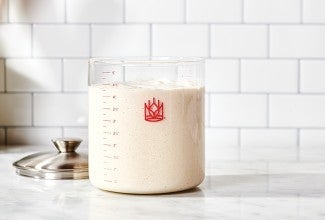 Crock of sourdough starter on kitchen counter