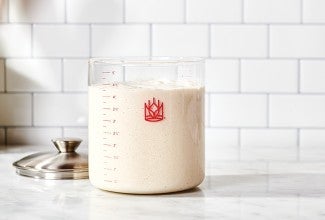 Crock of sourdough starter on kitchen counter