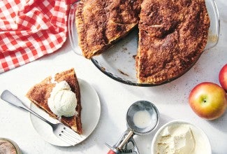 cinnamon and apple sugar pie with a slice taken out on a plate