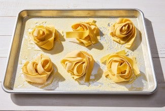 Fresh Pasta nests on a baking sheet