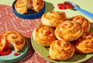 Pizza Party Buns served on plates with some tomato sauce