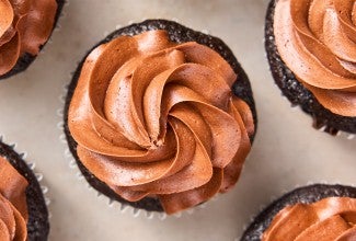Chocolate Buttercream frosting piped onto chocolate cupcakes