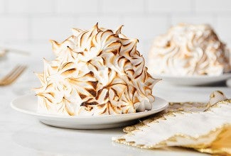 Swiss Meringue piped as a spiky and textured element on baked Alaska with browned edges.