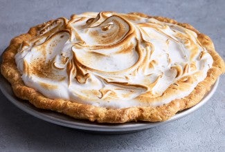 Swirled, baked, and lightly browned Swiss meringue atop a freshly baked pie.